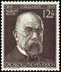 Briefmarkenausgabe des Großdeutschen Reichs, 'Robert Koch', 25.01.1944 / Quelle: Wikimedia Commons PD; Michel Junior-Katalog 1999. Deutsches Reich […], München 1997, S. 61 (Nr. 864).